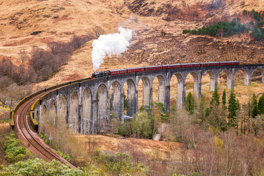 UK, Scotland, Jacobite steam train crossing Glenfinnan Viaduct