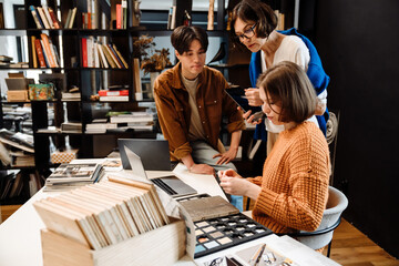 Group of architects choosing materials for interior design project in office