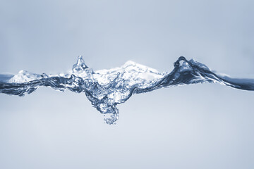 Water splash Aqua flowing in waves and creating bubbles Drops on the water surface feel fresh and clean isolated on white background.