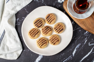Cocoa cookies. Delicious cookies on dark background. Top view