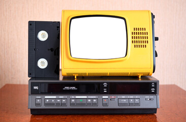 Old yellow vintage TV with white insulated screen to add new images to the screen, VCR in the...