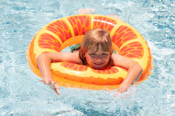 Kid in swimming pool. Kids summer vacation concept. Summer kids portrait in sea water on beach.