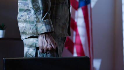 Fototapeta na wymiar Soldier carries a work suitcase and confidential documents in American office