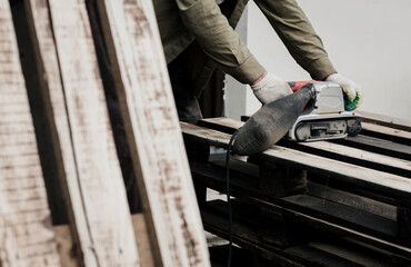 worker with belt sander