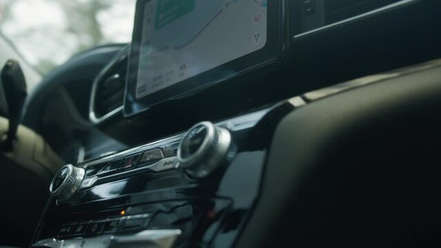 The car radio gleams with polished perfection, its sleek surface reflecting surrounding scenery and illuminating the interior, blending with captivating reflections of the world outside.