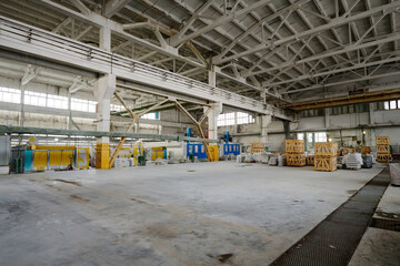 Horizontal image of big workshop with industrial machines and materials for production