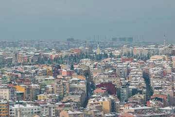 Obraz premium Istanbul city view in winter with snow covered houses roofs.