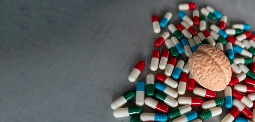 Colorful pills and brain with copy space for text. Mental illness, brain disease and mental health...