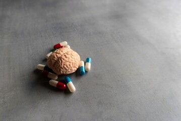 Colorful pills and brain with copy space for text. Mental illness, brain disease and mental health...