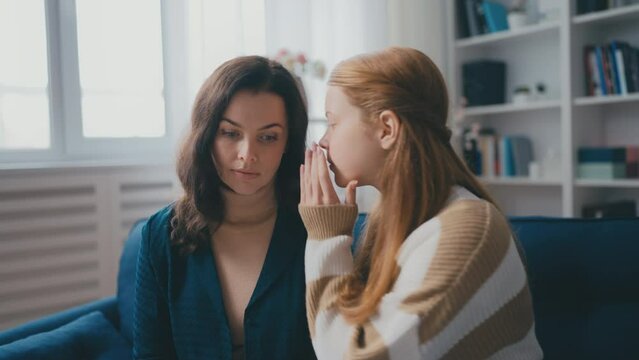 Teenage girl sharing secrets with her mother, trustful relationship, friends