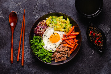 Traditional Korean dish Bibimbap: rice with vegetables beef and egg.