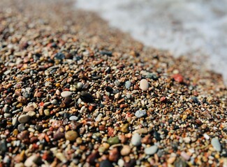 Natural sea pebbles, wet pebbles, small pebble background
