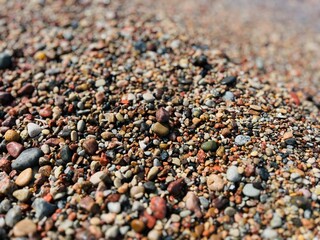 Natural sea pebbles, wet pebbles, small pebble background