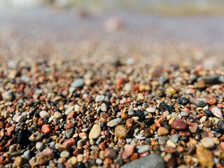 Natural sea pebbles, wet pebbles, small pebble background