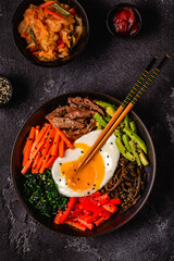 Traditional Korean dish Bibimbap: rice with vegetables beef and egg.