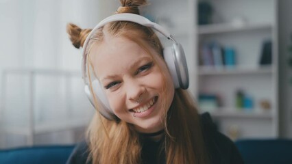 Portrait of happy teen girl in headphones at home, rebellious phase, subculture