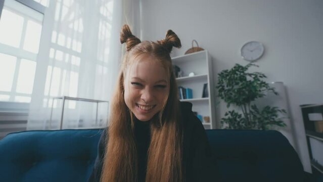Portrait of rebellious teenage girl winking on camera, puberty, teen rebellion