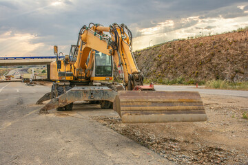 Excavator building a road in a site construction