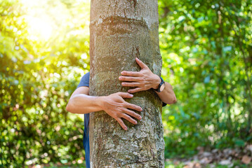 He wrapped his arms around the big tree in the park.