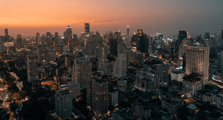 Naklejka premium Skyline panorama of Illuminated Bangkok city metropolis in twilight during the sunset. Scenic panoramic urban colorful cityscape of modern city on dusk. High-angle view