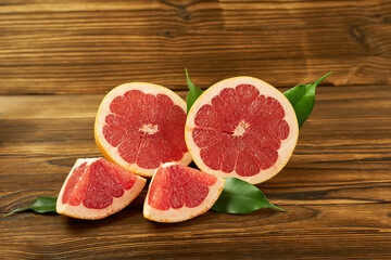 Grapefruit on a wooden background. Grapefruit with leaves.