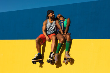Cheerful couple with roller skating outside. Fun sexy boyfriend and girlfriend enjoy outside.