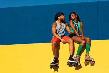Cheerful couple with roller skating outside. Fun sexy boyfriend and girlfriend enjoy outside.