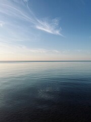 Blue sea horizon with some light clouds, seascape background