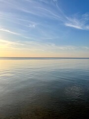 Blue sea horizon with some light clouds, seascape background