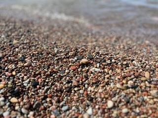 Natural sea pebbles, wet pebbles, small pebble background