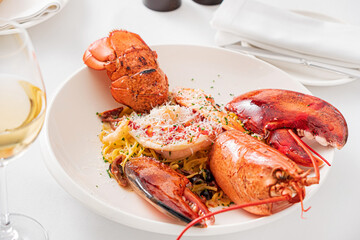 Fresh cooked American lobster on a plate with lemon and parsley