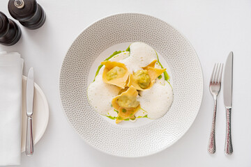 Tasty cooked ravioli with cream sauce