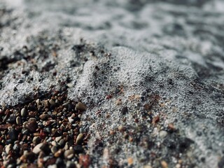 Natural sea pebbles, wet pebbles, small pebble background