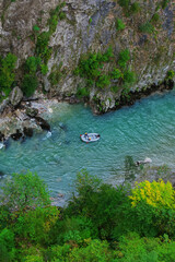 Top view of a team of people during a boat ride on a mountain river. Rafting in the mountains.