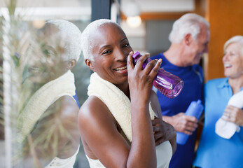 Older woman drinking water after workout - obrazy, fototapety, plakaty