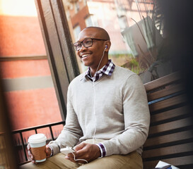 Man listening to mp3 player on city street
