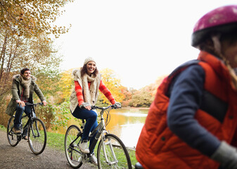 Fototapeta premium Family riding bicycles together in park