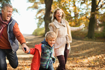 Fototapeta premium Boy and grandparents walking in park
