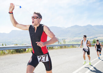 Runner spraying himself with water in race
