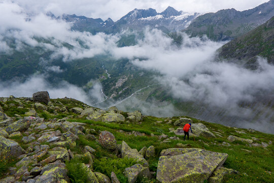 Hiking - hiker woman on trek with backpack living healthy active lifestyle. Hiker girl walking on hike in mountain nature landscap, zirrel aps, Austria alps, Switzerland.