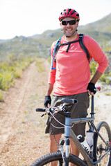 Mountain biker smiling on dirt path