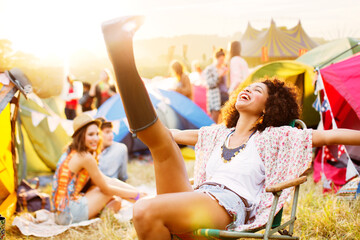 Carefree woman outside tents at music festival