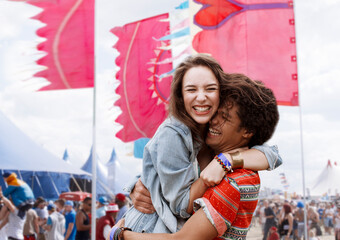 Enthusiastic couple hugging at music festival