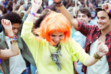 Woman in wig dancing at music festival