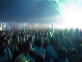 Crowd facing illuminated stage