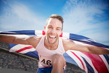 Track and field athlete cheering with British flag