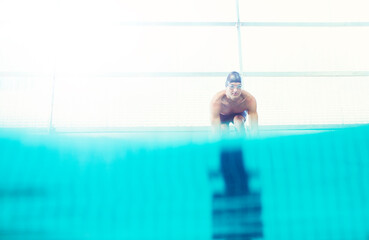 Fototapeta Swimmers poised on starting blocks obraz