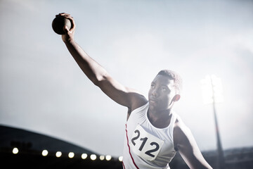 Track and field athlete throwing shot put