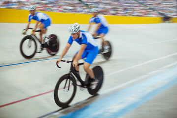 Track cycling team riding in velodrome