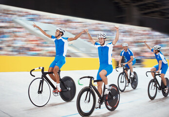 Track cycling team celebrating in velodrome